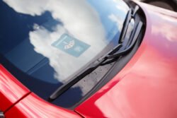 Car wipers on the red car karta parkingowa